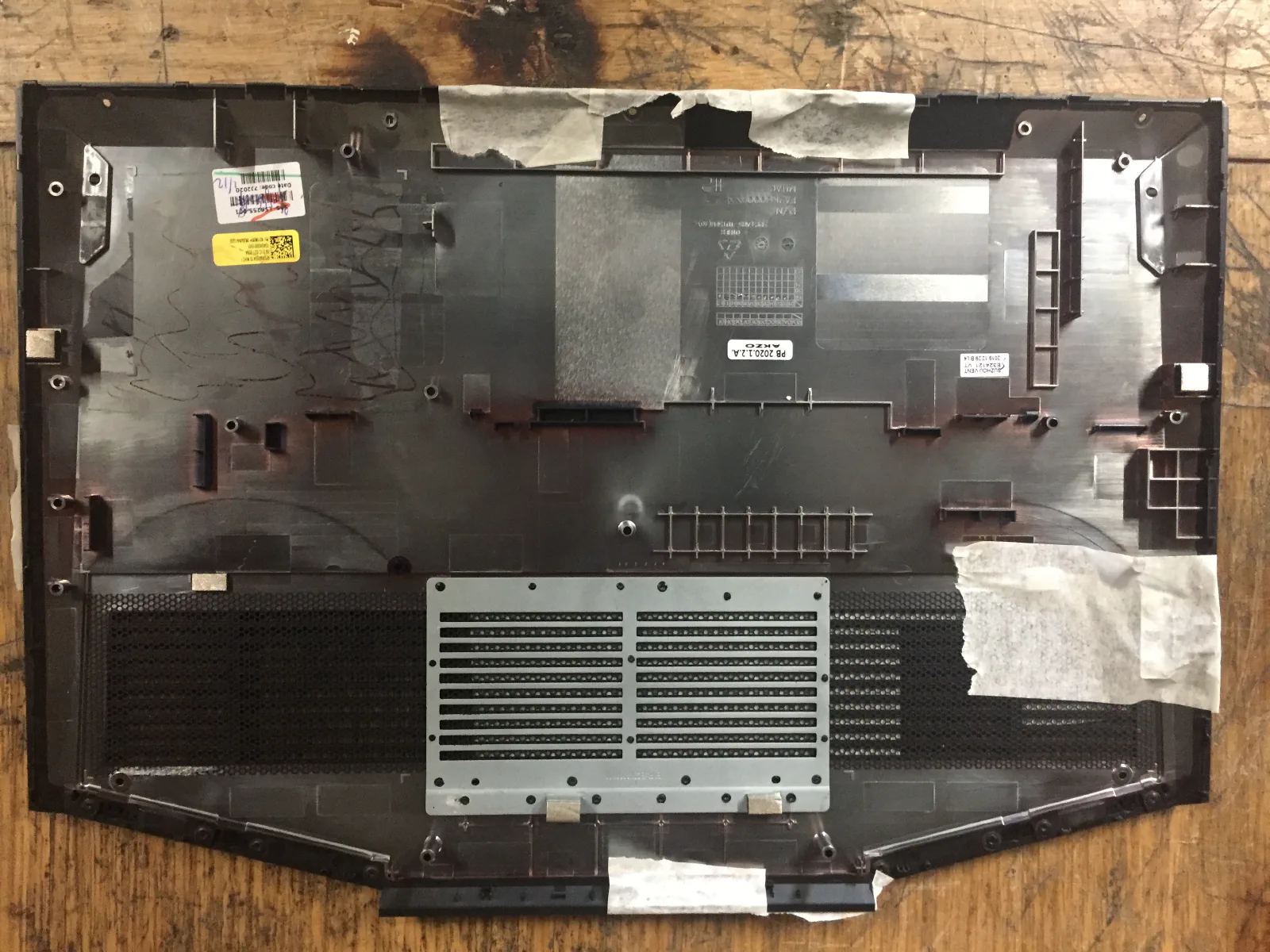 Bottom cover of the laptop with marked area to be cut